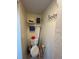 Compact bathroom with a toilet, rack, and a charming decorative duck figurine at 12613 4Th Isle, Hudson, FL 34667