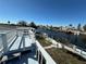 A view from an elevated deck showcases the serene canal and surrounding waterfront neighborhood homes at 12613 4Th Isle, Hudson, FL 34667