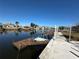 Image of the home's weathered wood private dock and boat lift on the canal at 12613 4Th Isle, Hudson, FL 34667