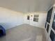 Tiled, enclosed porch with door and window, providing a comfortable, relaxing space at 12613 4Th Isle, Hudson, FL 34667