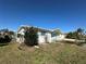 Charming single-story home featuring a bright white exterior, blue shutters and door with landscaping at 12613 4Th Isle, Hudson, FL 34667