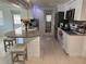 Modern kitchen with granite countertops, white cabinets, and stainless steel appliances offers a sleek and functional design at 12613 4Th Isle, Hudson, FL 34667