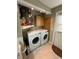Functional laundry area with washer, dryer, and built-in cabinets for efficient storage at 12613 4Th Isle, Hudson, FL 34667