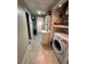 Well-equipped laundry area with modern appliances and convenient access to additional storage at 12613 4Th Isle, Hudson, FL 34667