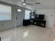 Well-lit living room featuring tile floors, a ceiling fan, and entertainment center for comfortable living at 12613 4Th Isle, Hudson, FL 34667