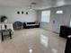 Bright living room featuring tile floors, modern furniture, and ample natural light creates a welcoming space at 12613 4Th Isle, Hudson, FL 34667