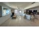 Open floor plan featuring tile floors, ceiling fan, breakfast bar, and a modern kitchen at 12613 4Th Isle, Hudson, FL 34667