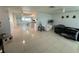 Spacious open-concept living room with tile flooring, bright lighting, and seamless flow into the kitchen at 12613 4Th Isle, Hudson, FL 34667
