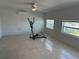 Room featuring tile floor, ceiling fan, mini-split and two windows at 12613 4Th Isle, Hudson, FL 34667