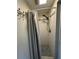 Cozy shower featuring blue and white tiling and a convenient shower head fixture at 12613 4Th Isle, Hudson, FL 34667