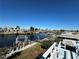 Waterfront view with dock, boat lift, and blue wood deck overlooking the canal at 12613 4Th Isle, Hudson, FL 34667