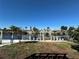 Image of the backyard with waterfront views, including a wood dock, and boat lift on the canal at 12613 4Th Isle, Hudson, FL 34667