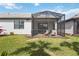 A backyard with a screened lanai, lawn, and home exterior at 13867 Vadini St, Venice, FL 34293
