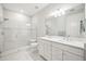 Modern bathroom featuring double sinks, a glass shower, and neutral tiles at 13867 Vadini St, Venice, FL 34293