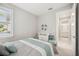 Bedroom featuring a window with blinds, a dresser, and access to the bathroom at 13867 Vadini St, Venice, FL 34293