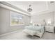 Serene bedroom featuring a tray ceiling, plantation shutters and a luxurious bed with side tables at 13867 Vadini St, Venice, FL 34293