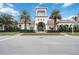 Clubhouse facade with arched entryways, a tile roof, and lush landscaping at 13867 Vadini St, Venice, FL 34293