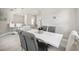 Open dining area with modern decor, a decorative mirror, and stylish bar seating nearby at 13867 Vadini St, Venice, FL 34293