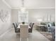 Elegant dining room featuring a modern chandelier and a white dining table that seats six at 13867 Vadini St, Venice, FL 34293