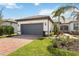 Well-manicured lawn and landscaping complement this single-story home with brick driveway and a tile roof at 13867 Vadini St, Venice, FL 34293