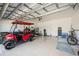 Spacious garage featuring a golf cart, ample storage, and epoxy flooring at 13867 Vadini St, Venice, FL 34293