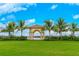 Picturesque gazebo surrounded by a well-maintained lawn and palm trees at 13867 Vadini St, Venice, FL 34293