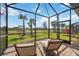 Relaxing screened lanai area with comfortable seating and picturesque views at 13867 Vadini St, Venice, FL 34293