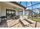 Outdoor living with dining and lounge seating on the brick-paved lanai at 13867 Vadini St, Venice, FL 34293