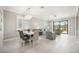 Open-concept living area with a modern chandelier, tile floors, and ample natural light at 13867 Vadini St, Venice, FL 34293