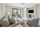 Stylish living area with comfortable seating, modern decor, and a sliding door to outdoor space at 13867 Vadini St, Venice, FL 34293