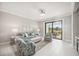 Bright living area with sliding glass doors, tile flooring, comfortable seating, and a view of the lanai at 13867 Vadini St, Venice, FL 34293