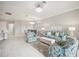 Open-concept living and dining area with tile floors, modern lighting, and comfortable seating arrangement at 13867 Vadini St, Venice, FL 34293
