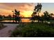 Picturesque sunset view over a tranquil lake with a charming bridge at 13867 Vadini St, Venice, FL 34293