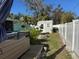 Backyard view featuring a hot tub, shed, fire pit, and partial view of the home and fenced perimeter at 1449 Everest Rd, Venice, FL 34293