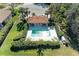 Aerial shot of a community pool and recreation area, surrounded by manicured landscaping and residential properties at 161 Valencia Lakes Dr, Venice, FL 34292