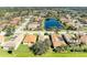 Expansive aerial view of community homes, showcasing a tranquil pond and lush greenery around residential area at 161 Valencia Lakes Dr, Venice, FL 34292