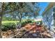 Backyard with a hammock, outdoor seating, firepit area, and manicured landscaping at 161 Valencia Lakes Dr, Venice, FL 34292