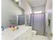 Well-lit bathroom featuring a single vanity, mirror, and shower with neutral tones at 161 Valencia Lakes Dr, Venice, FL 34292