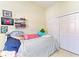 Bedroom featuring a cozy bed with colorful pillows and a spacious closet with paneled doors at 161 Valencia Lakes Dr, Venice, FL 34292