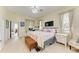 Comfortable bedroom with a bed, bench, and a dedicated workspace at 161 Valencia Lakes Dr, Venice, FL 34292