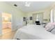 Cozy bedroom with light-colored walls, luxury vinyl floors, and an ensuite bathroom at 161 Valencia Lakes Dr, Venice, FL 34292