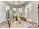 Cozy dining area with modern wood table, bright natural light, tile floors and decorative ceiling fan at 161 Valencia Lakes Dr, Venice, FL 34292