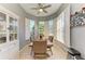 Inviting dining area with tile floors, bright natural light, decorative ceiling fan and modern table setting at 161 Valencia Lakes Dr, Venice, FL 34292