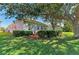 Exterior shot of the home with landscaping, and a private backyard at 161 Valencia Lakes Dr, Venice, FL 34292