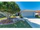 Charming home exterior with lush green landscaping at 161 Valencia Lakes Dr, Venice, FL 34292
