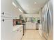 Spacious kitchen featuring modern appliances, white cabinets, lots of counter space and tile flooring at 161 Valencia Lakes Dr, Venice, FL 34292