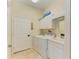 Functional laundry room equipped with modern washer, dryer, and storage cabinets at 161 Valencia Lakes Dr, Venice, FL 34292