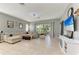 Bright and airy living room featuring tile floors and sliding glass doors at 161 Valencia Lakes Dr, Venice, FL 34292