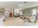 Open-concept living room with tile flooring, bar seating and a large window at 161 Valencia Lakes Dr, Venice, FL 34292