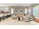 Spacious living room with tile flooring, neutral walls and comfortable seating at 161 Valencia Lakes Dr, Venice, FL 34292